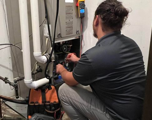 trusted furnace repair company in Kenosha HVAC technician inspecting a furnace, furnace repair company in Kenosha, Misurelli Sorensen Heating & Air Conditioning